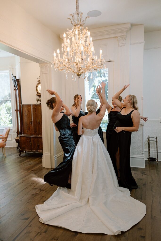 Bride and Bridesmaids cheer as they head out to the ceremony together before the bride gets married