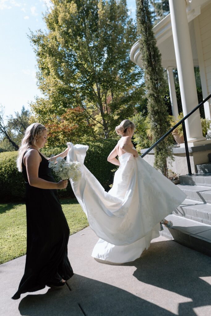 Bride poses with bridesmaids in black dresses on wedding day at Park Winters