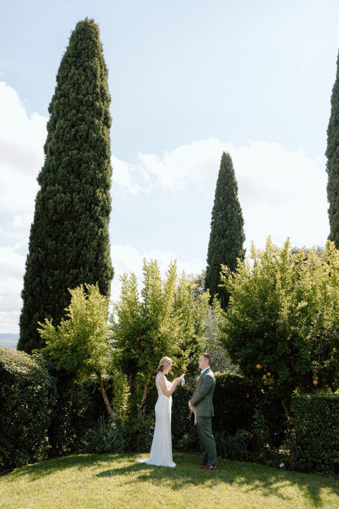 Bride and groom eloping in the rolling olive groves and sweeping countryside of Tuscany with natural light creating a timeless feel.