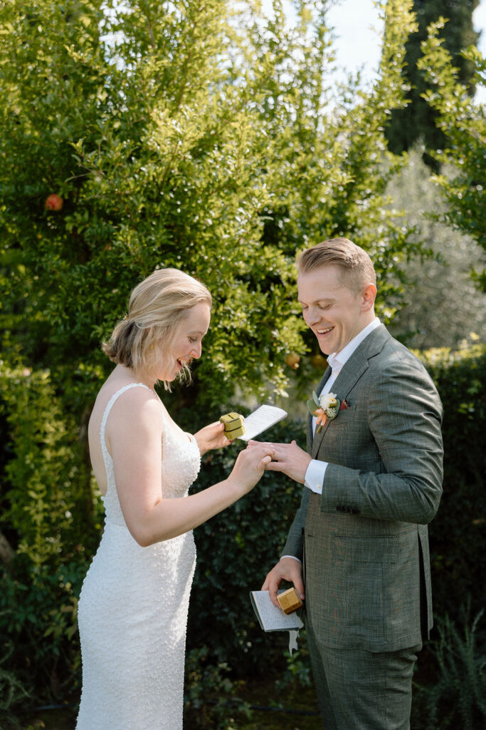 Private elopement ceremony in the Tuscan countryside, with the bride and groom focused on one another in an intimate moment.