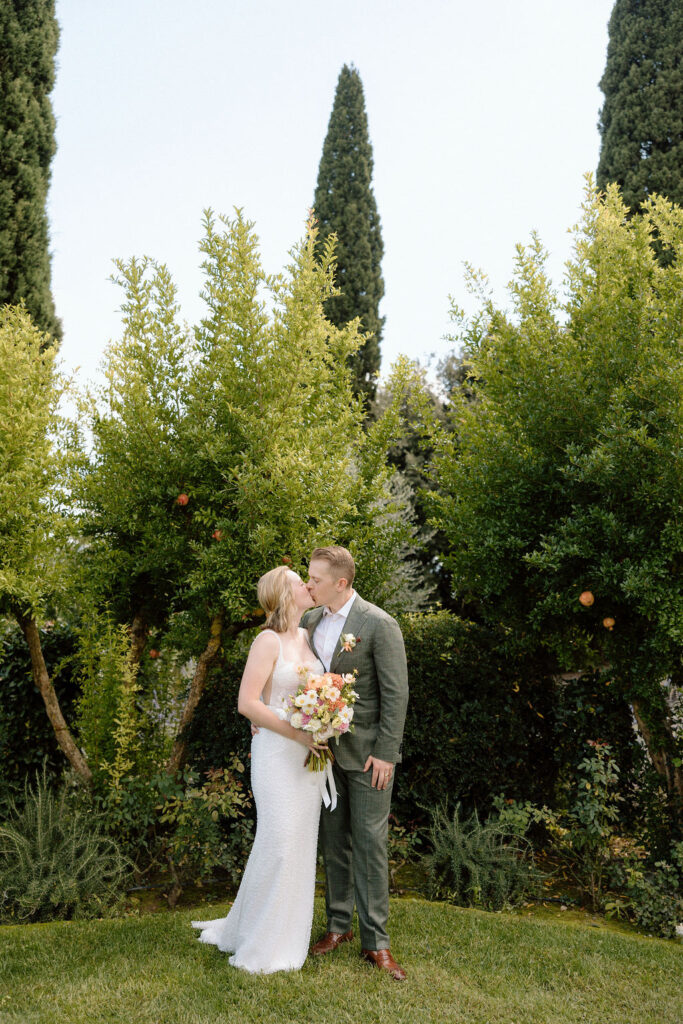 Bride and groom eloping in the rolling olive groves and sweeping countryside of Tuscany with natural light creating a timeless feel.