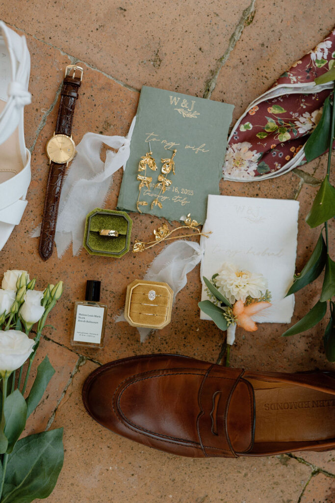 Floral and stationery flat lay designed by the bride, styled against Tuscan light as part of a romantic Italian elopement story.