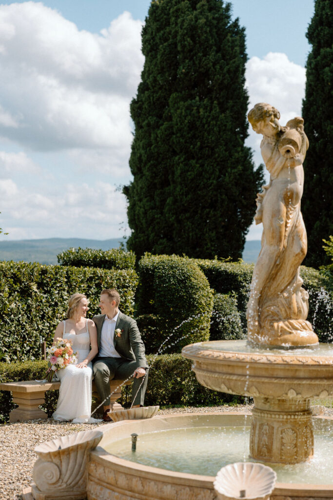 Bride and groom exploring the grounds of a Tuscan villa after their ceremony, embracing the quiet elegance of an Italian wedding.