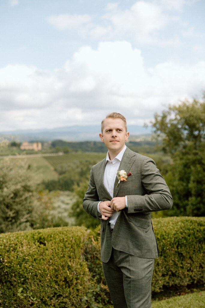 Calm and reflective groom getting ready before an intimate Tuscan elopement ceremony in Italy.