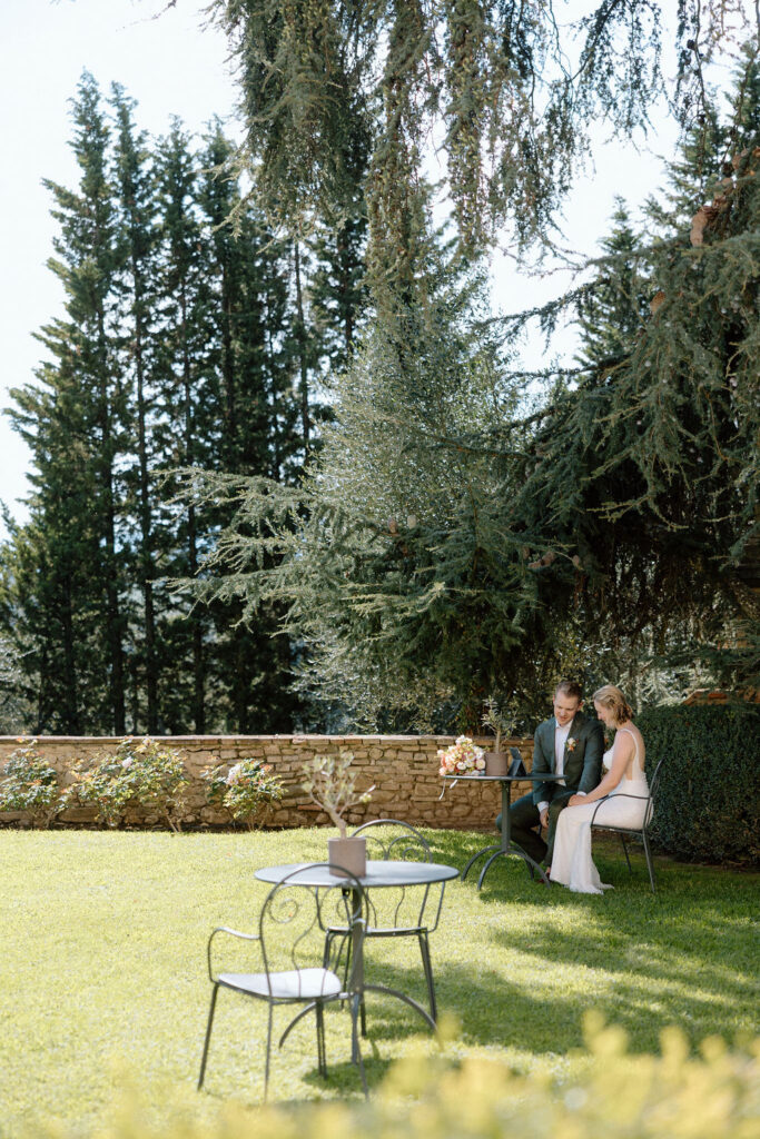 Emotional moment of the couple watching a heartfelt video message from loved ones at their Italian destination wedding.