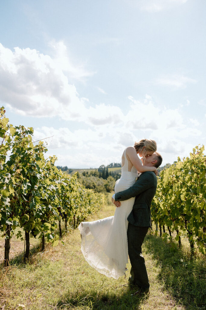 Bride and groom exploring vineyard paths in Tuscany after their ceremony, embracing the slow, romantic pace of an Italian elopement.