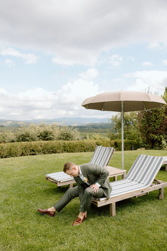 Editorial portrait of the groom getting ready for his elopement in Tuscany, surrounded by timeless villa details.