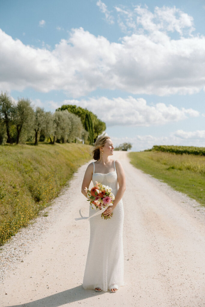 Scenic portrait of the couple overlooking the Tuscan countryside at COMO Castello Del Nero, celebrating their elopement in Italy.