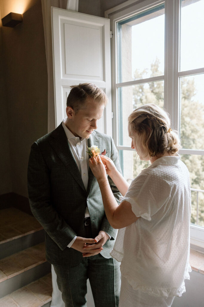 “Calm getting-ready moments before a Tuscan elopement, capturing the bride’s excitement and quiet joy.