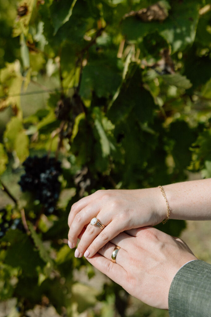 Bride and groom walking hand in hand through sunlit vineyards in Tuscany during an intimate Italian destination wedding.