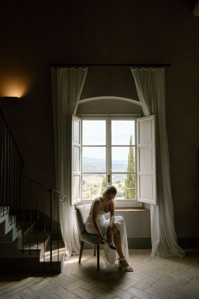 Bride finishing her getting-ready process for an intimate Italian destination wedding, photographed with an editorial and romantic approach