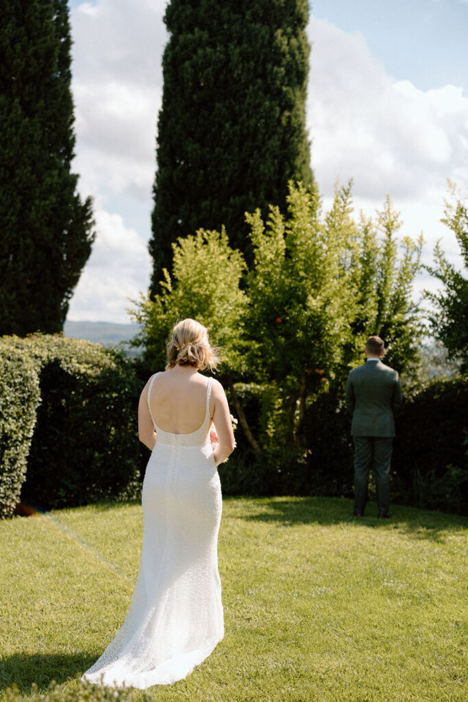 Private elopement ceremony in the Tuscan countryside, with the bride and groom focused on one another in an intimate moment.