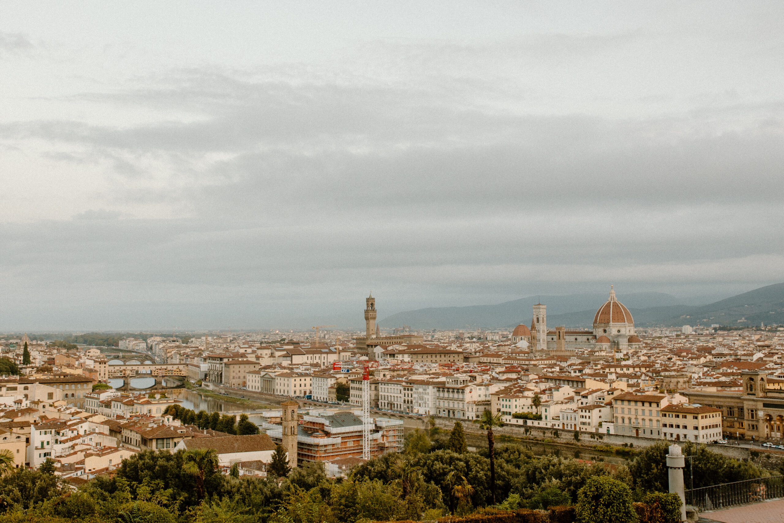 Skyline view of Florence Italy with a slightly cloudy sky taken by destination wedding photographer Katelyn Bradley Photography